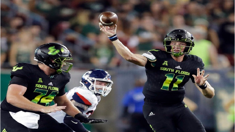 USF quarterback Blake Barnett (11) fires a pass against Connecticut during the first half of an NCAA college football game Saturday, Oct. 20, 2018, in Tampa, Fla. (AP Photo/Chris O'Meara)